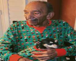 The star is accompanied by a furry friend in his home.